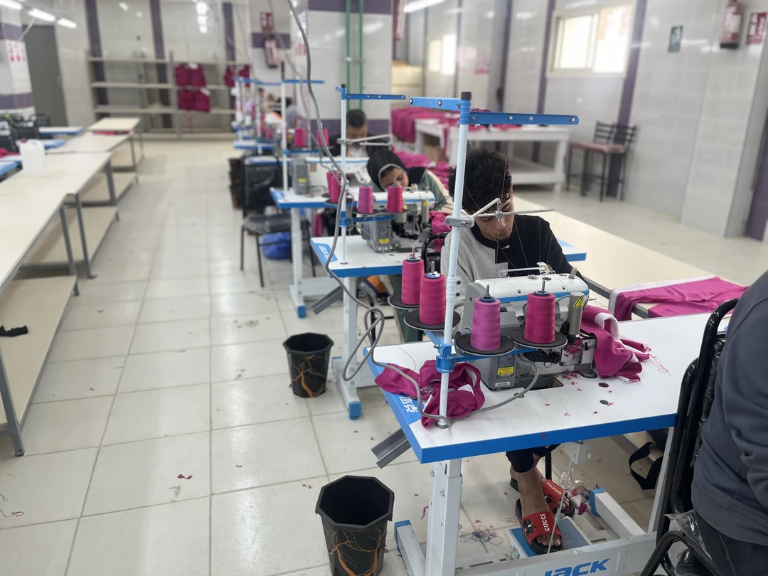Production workers operating sewing machines on the garment floor